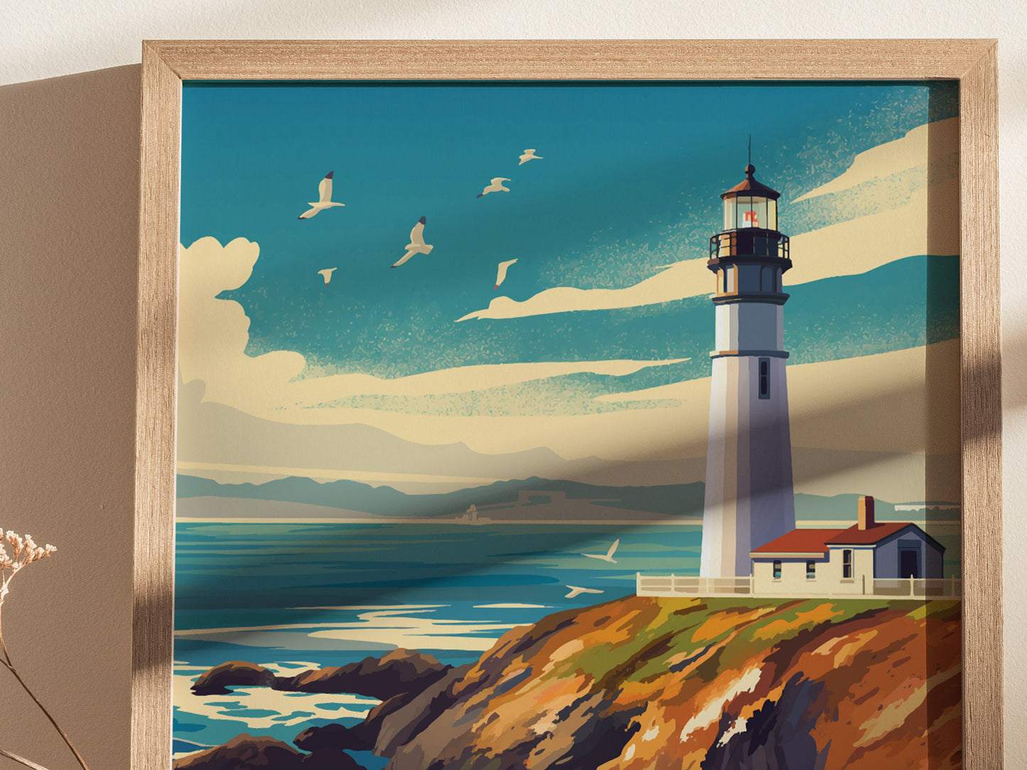 A framed poster depicting Pigeon Point Lighthouse on a cliff with a vibrant blue sky, scattered clouds, and seagulls in flight. The ocean waves crash against the rocky shore.
