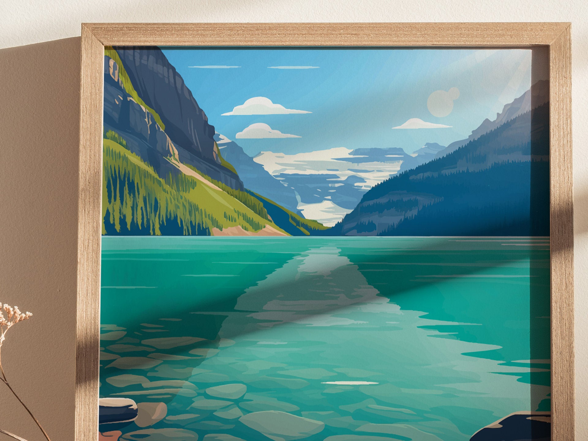 A framed illustration of Lake Louise shows turquoise waters, surrounded by green forested mountains under a clear blue sky with white clouds, capturing the serene beauty of the Canadian Rockies.