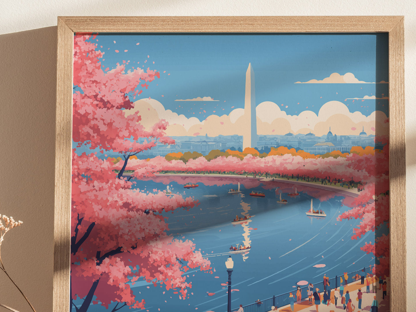 A framed poster depicts Washington DCs cherry blossom festival, showcasing vibrant pink blossoms along a waterway. The Washington Monument stands in the background under a clear blue sky, with people enjoying the view.