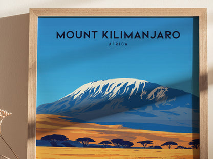 Framed poster of Mount Kilimanjaro with a snow-capped peak, set against a blue sky and golden savanna. African acacia trees dot the landscape, enhancing the vibrant scene.
