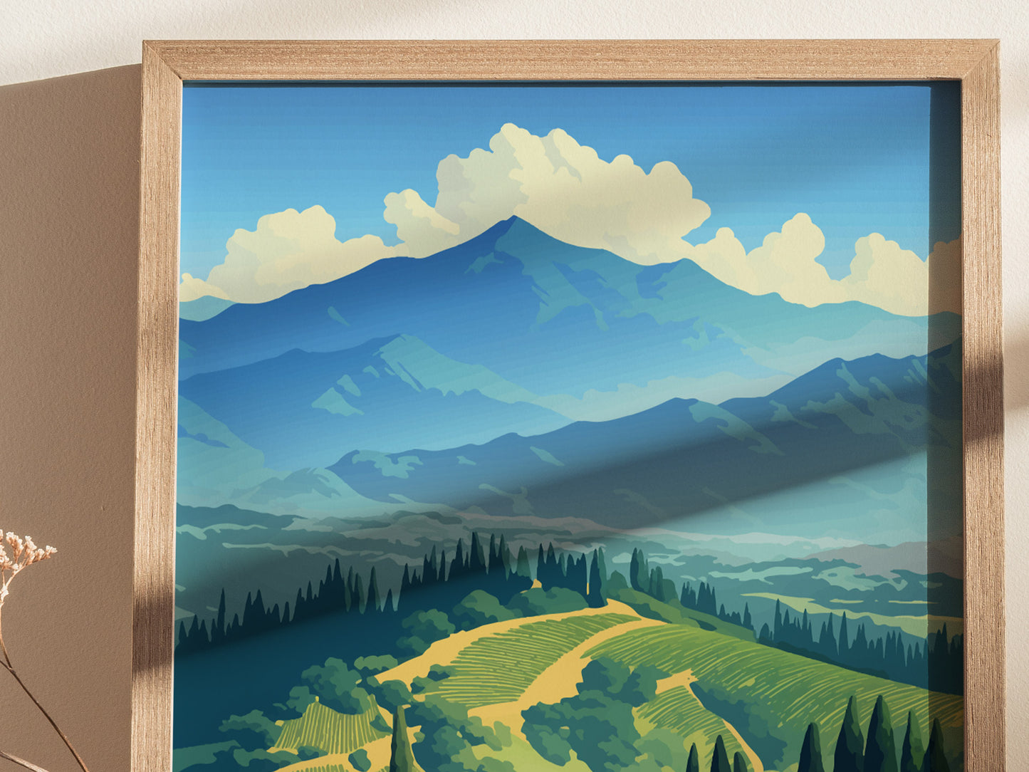 A framed poster depicts vibrant vineyard hills with lush greenery and towering mountains under a blue sky with fluffy clouds. The artwork captures a serene, picturesque landscape.