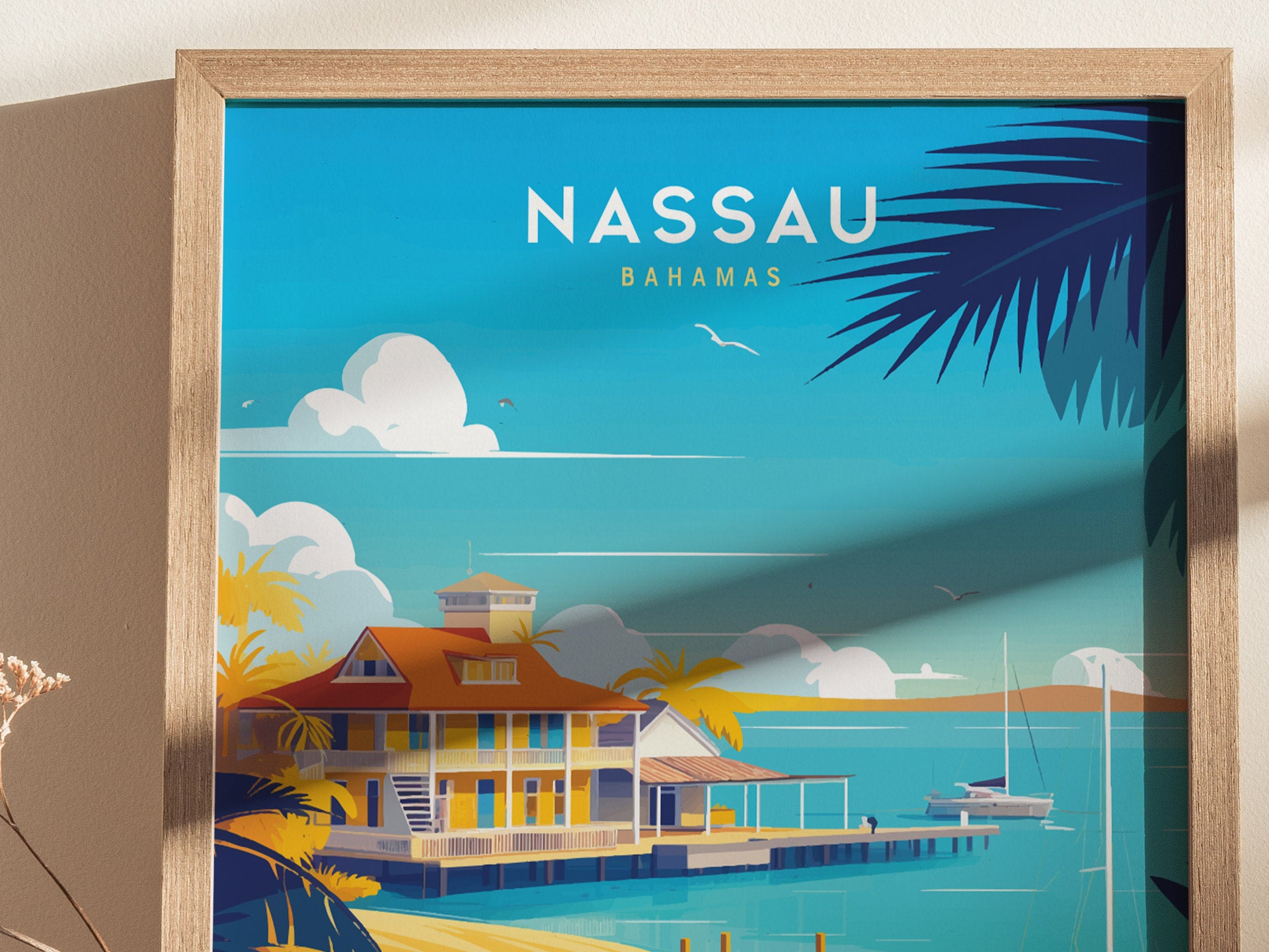 Illustrated poster featuring a colorful beachfront scene in Nassau, Bahamas, with a vibrant house, palm trees, and turquoise water under a clear blue sky. Framed in light wood.