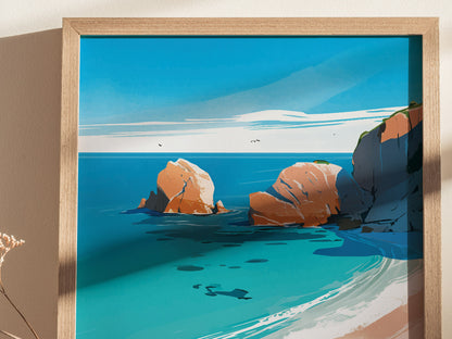 A framed print depicting a stylized coastal scene with turquoise waters, large orange rocks, and a sandy beach under a clear blue sky.