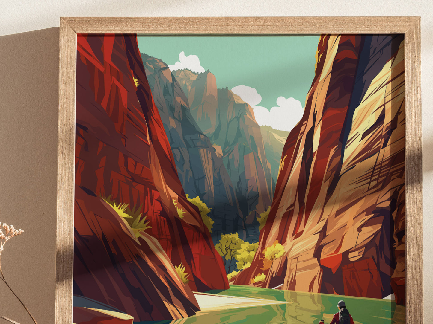 A framed poster depicts a dramatic slot canyon scene with towering red rock walls, a vibrant green river, and a hiker in the foreground, under a clear, blue sky.