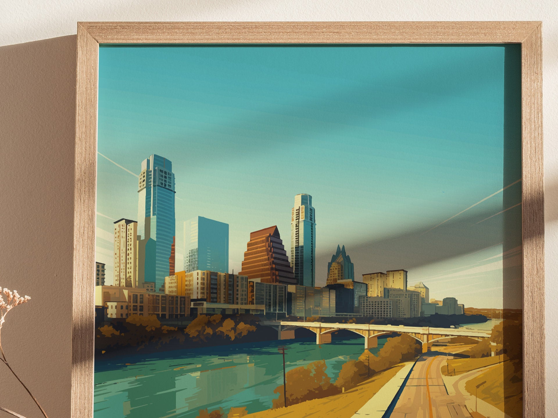 A framed illustration of the Austin, Texas skyline features modern skyscrapers and a bridge over a river. The artwork is set against a clear blue sky.