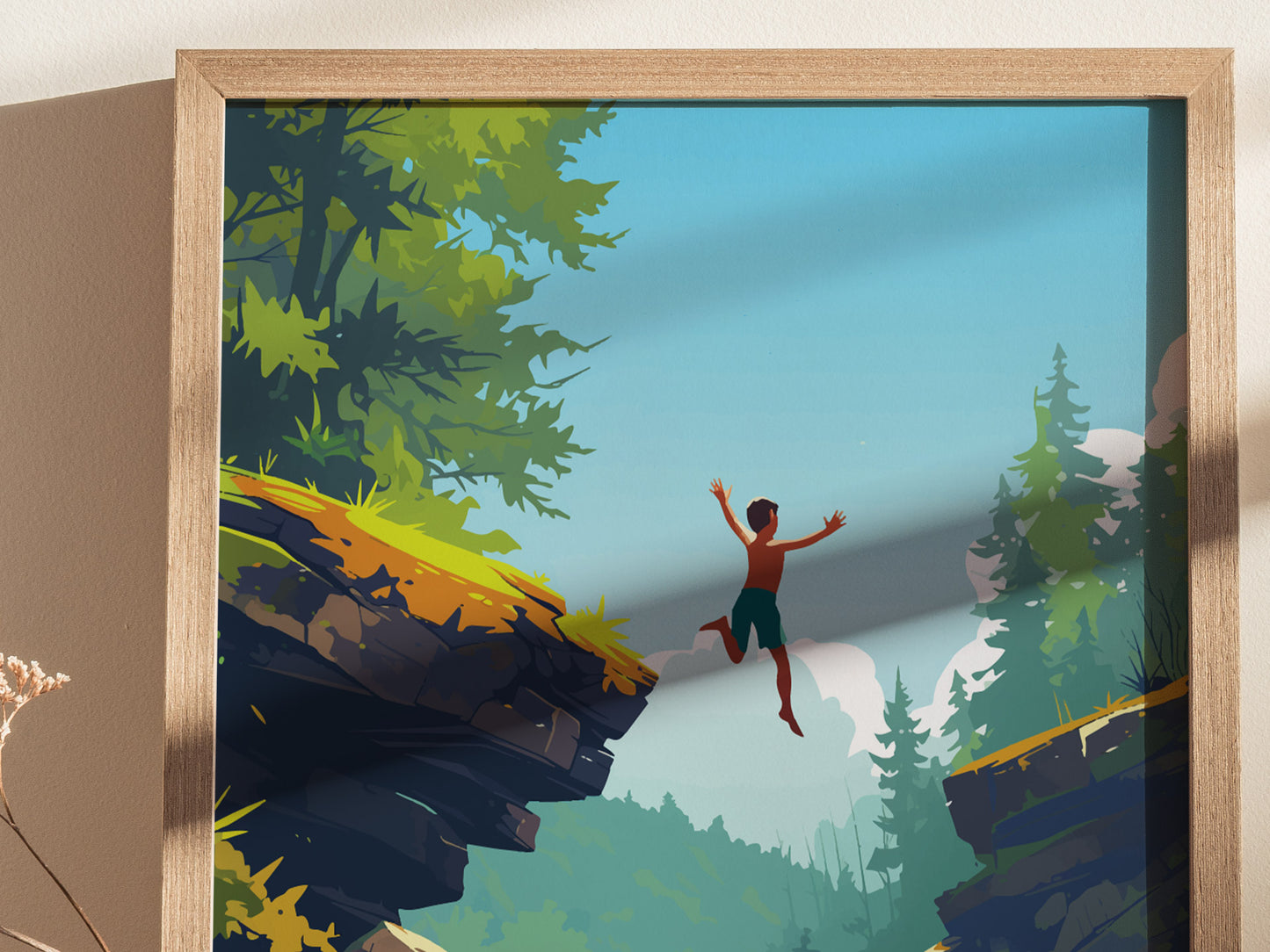 A framed poster depicts a silhouette of a person joyfully leaping from a rocky cliff surrounded by lush, green trees under a bright blue sky. The scene captures a sense of adventure and freedom in a natural setting.