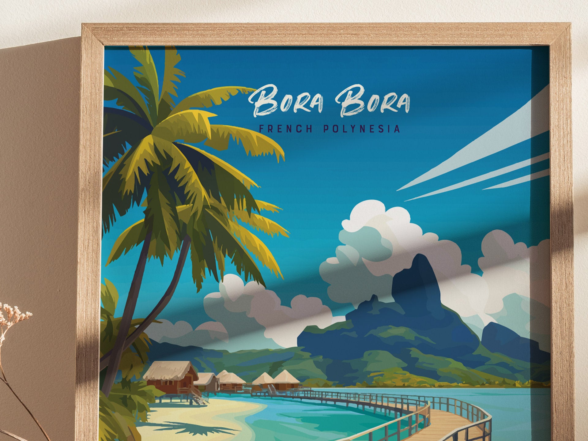 A framed travel print of Bora Bora depicts a tropical scene with palm trees, turquoise water, overwater bungalows, and lush mountains under a bright blue sky.