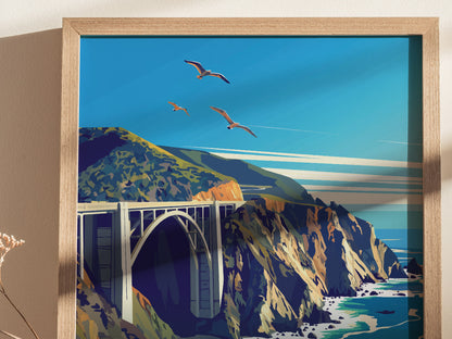 Framed poster depicting Bixby Bridge spanning rugged cliffs with soaring seagulls above and turquoise ocean waves below, set against a vibrant blue sky.