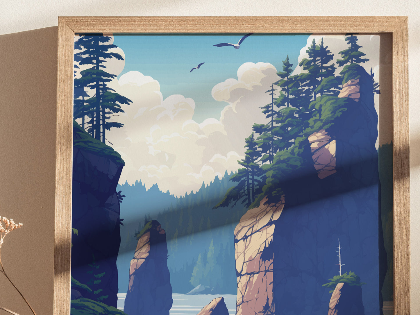 Illustrated poster depicting a scenic landscape with towering rock formations, lush pine trees, and birds flying in a clear blue sky. The artwork is framed in light wood.