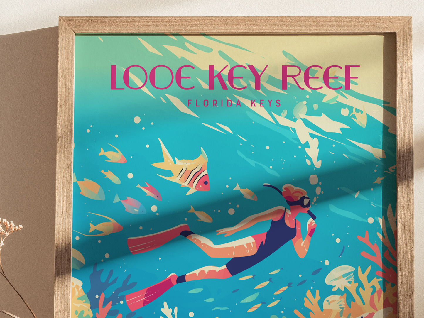 A colorful poster depicting a snorkeler swimming among vibrant tropical fish and coral in the Looe Key Reef, Florida Keys, framed in a wooden border.