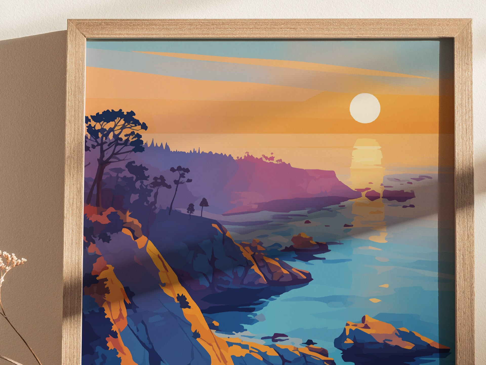 A vibrant poster depicts a stylized sunset over a rocky coastline with cliffs, trees, and the ocean. The artwork features rich hues of orange, purple, and blue.