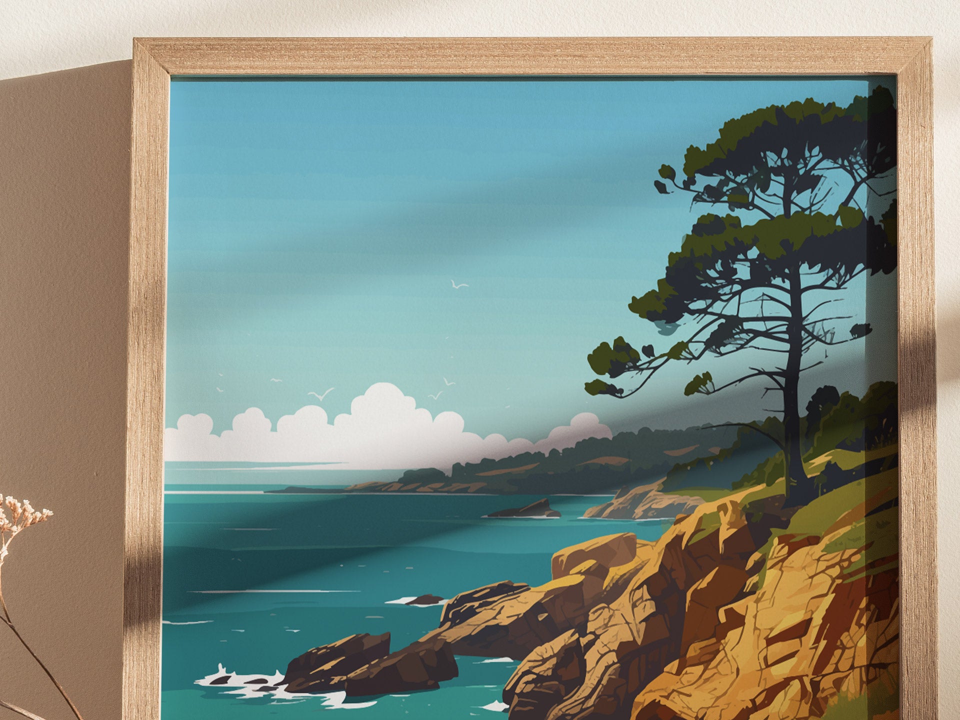 Framed artwork depicts a scenic coastal view with rocky cliffs, a lone tree, and the ocean under a clear blue sky with fluffy clouds.