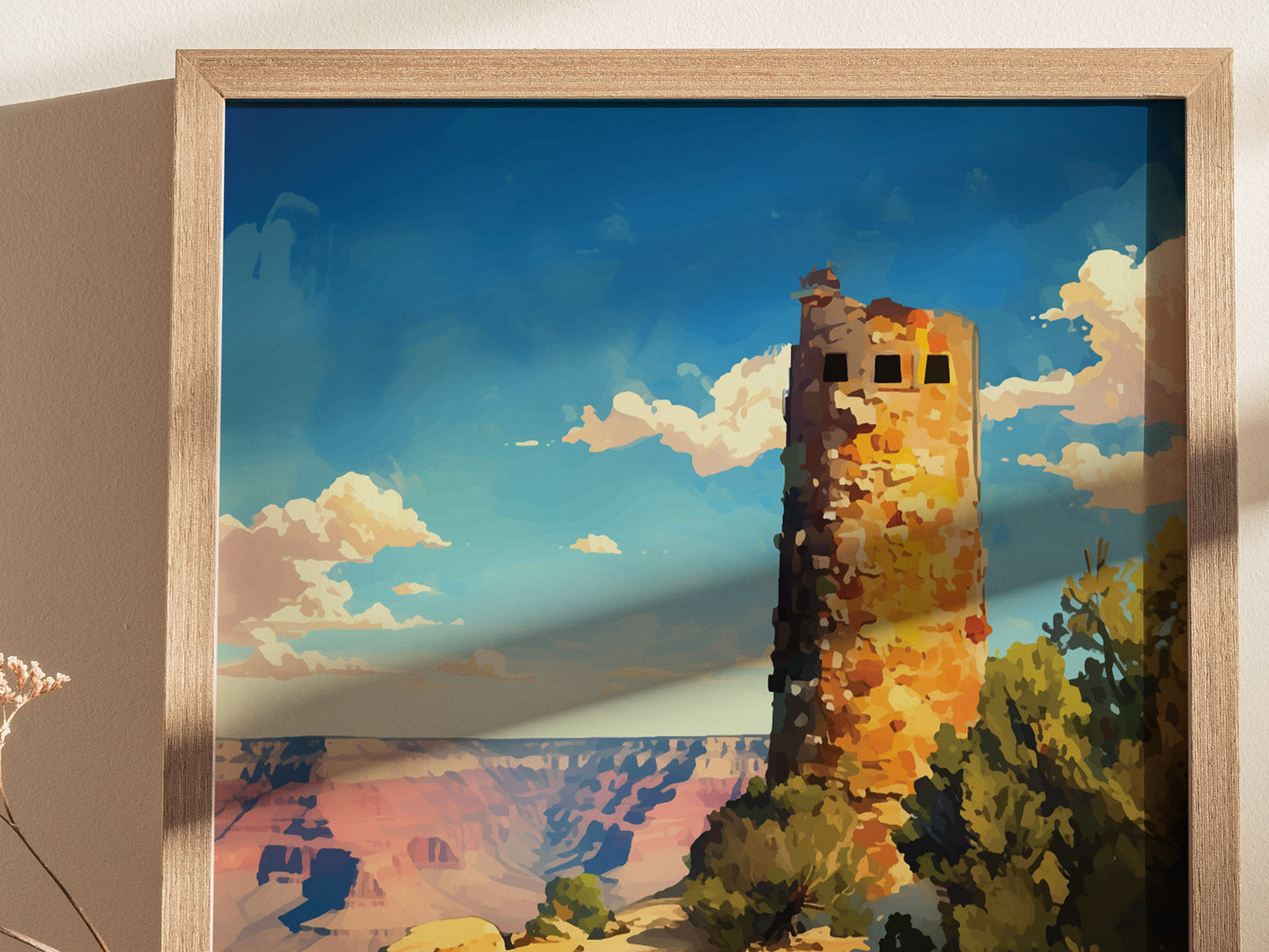 A framed poster depicts the Desert View Watchtower against a vibrant blue sky with scattered clouds, set at the Grand Canyons edge. The artwork captures warm, earthy tones beautifully.