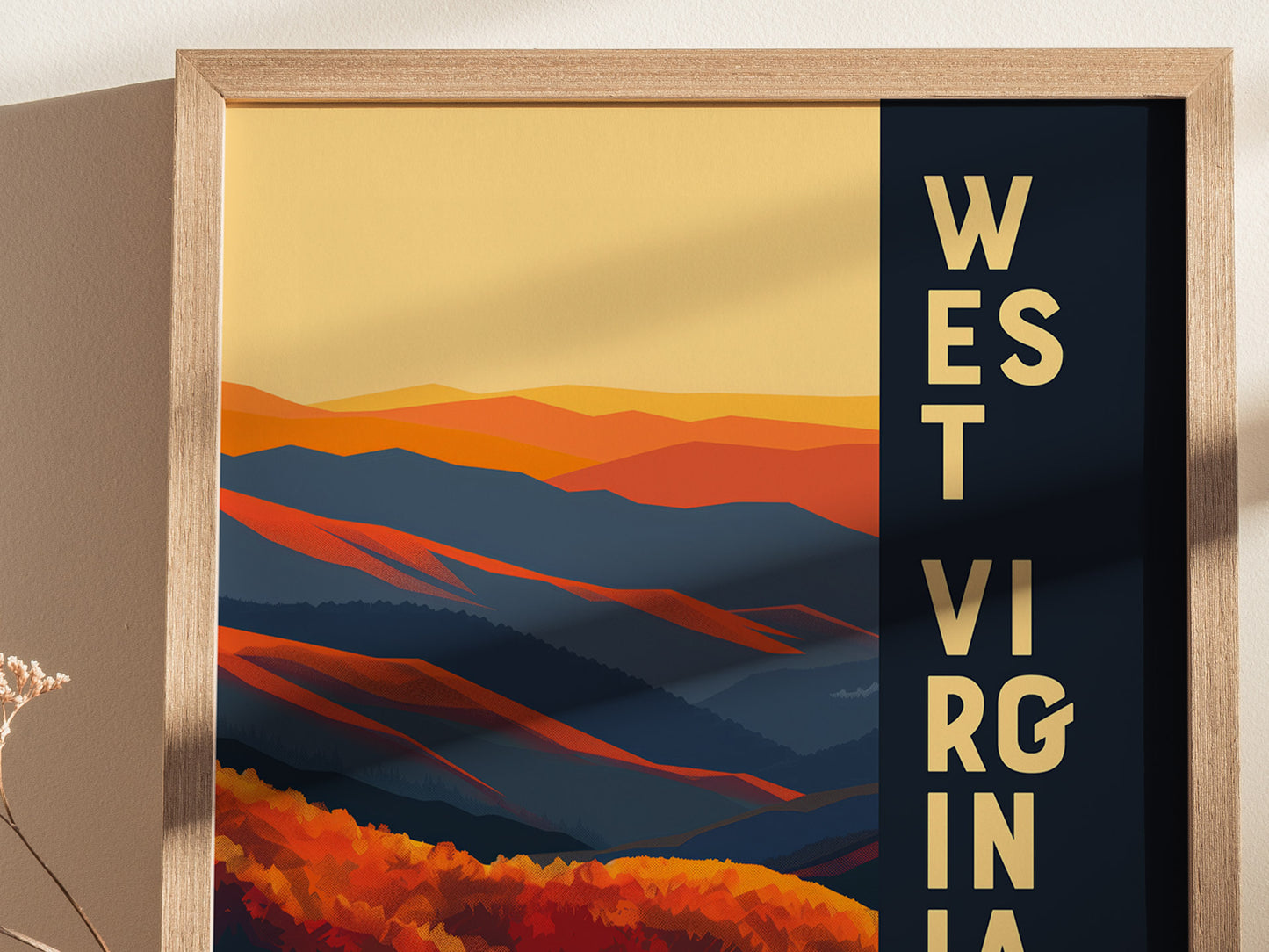 A framed poster displaying abstract, colorful mountain ranges in shades of orange and blue with the text WEST VIRGINIA vertically on a dark background.