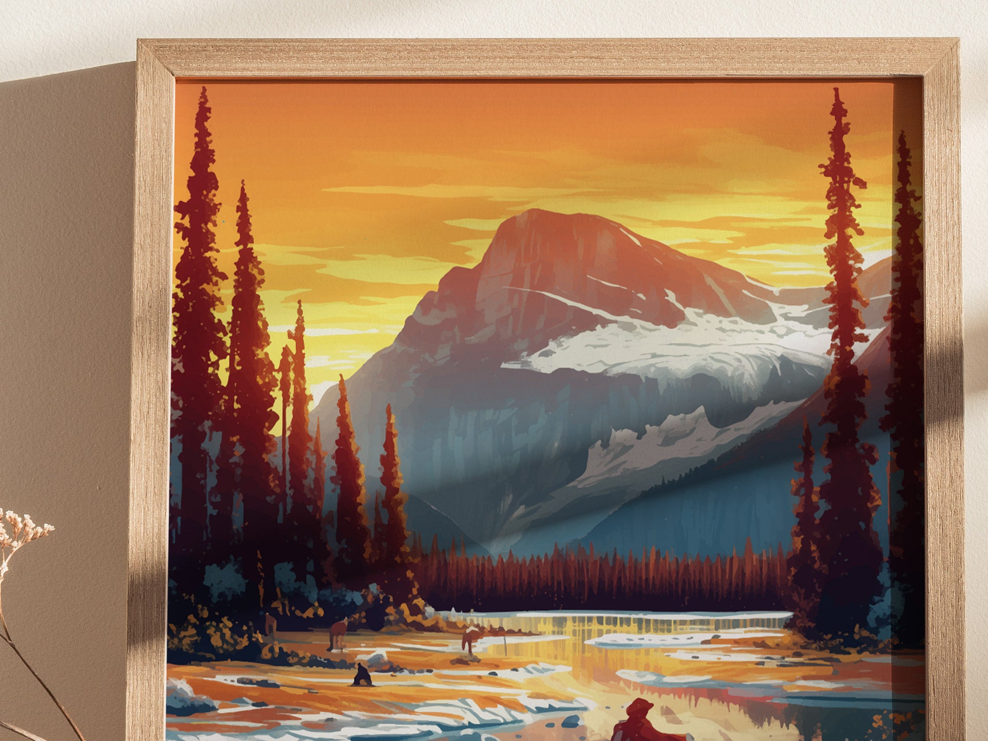 A framed poster of a mountain landscape at sunset, featuring tall pine trees, snow-capped peaks, and a reflective river. The vibrant colors create a serene, natural scene.