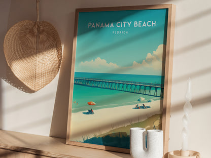 Framed poster of Panama City Beach, Florida, featuring a pier, beachgoers, and umbrellas under a bright sky. Set against a wall with a woven basket and decorative items nearby.