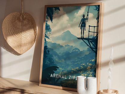 Framed Arenal Zipline Adventure poster depicting a person on a platform overlooking a lush rainforest with a distant mountain. A woven basket and decorative candle are nearby.
