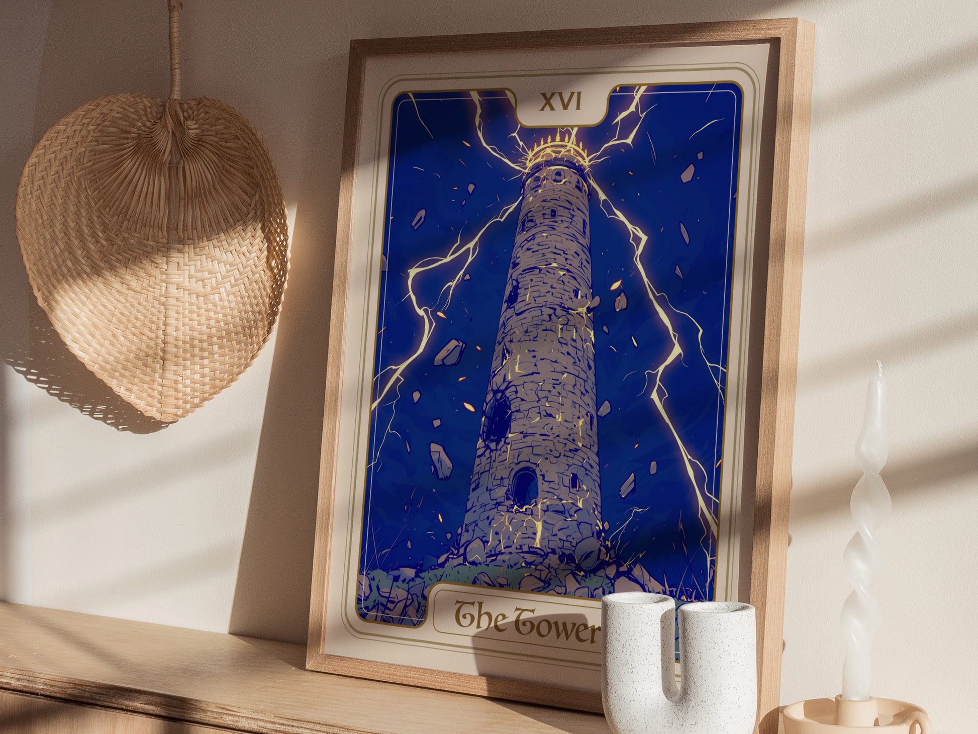 A framed poster of The Tower Tarot card features a tall, stone tower struck by lightning, surrounded by dramatic blue skies and falling debris.