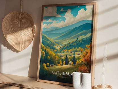 A framed Gatlinburg poster depicting lush, colorful mountains under a cloudy sky sits on a wooden shelf, accompanied by a woven basket and a uniquely shaped candle.