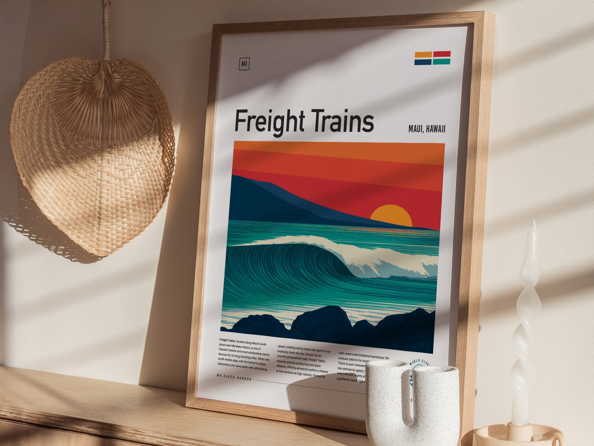 A framed poster titled Freight Trains features a stylized ocean wave beneath a vivid sunset with red and orange hues, set against a backdrop of dark rocks.