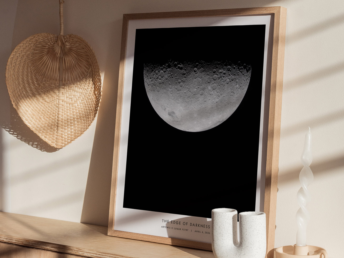 A framed poster titled The Edge of Darkness features a detailed close-up of the moons surface, showcasing its craters and textures against a black background.
