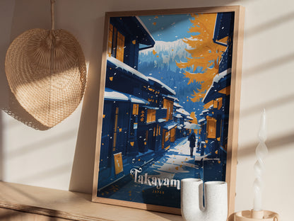 Framed Takayama Japan poster depicting a snowy street scene with traditional buildings and vibrant autumn leaves. The artwork is displayed on a wooden shelf next to decorative items.