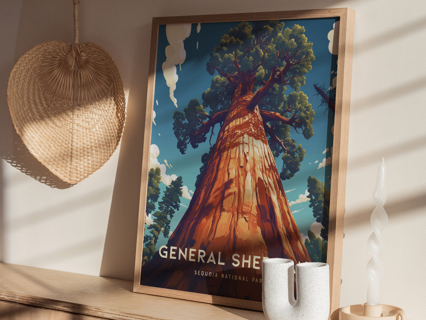 A framed poster of the General Sherman Tree in Sequoia National Park leans against a wall, next to a woven basket and decorative candle.