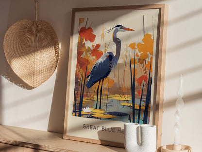 A framed poster of a Great Blue Heron in a stylized wetland scene with orange leaves is displayed on a wooden shelf. A woven basket and decorative candle are nearby.