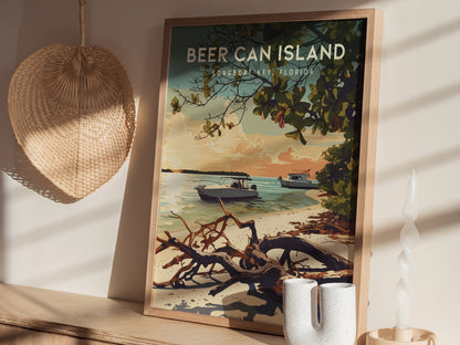 A framed poster of Beer Can Island, Longboat Key, Florida, sits on a wooden surface, depicting boats on tranquil waters near a sandy beach with driftwood and trees. The scene is set in a warm, tropical sunset atmosphere.