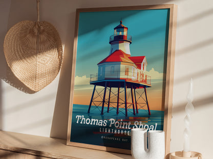 A framed poster of Thomas Point Shoal Lighthouse with vibrant colors sits on a wooden surface, next to a woven wall decoration and a unique white candle.