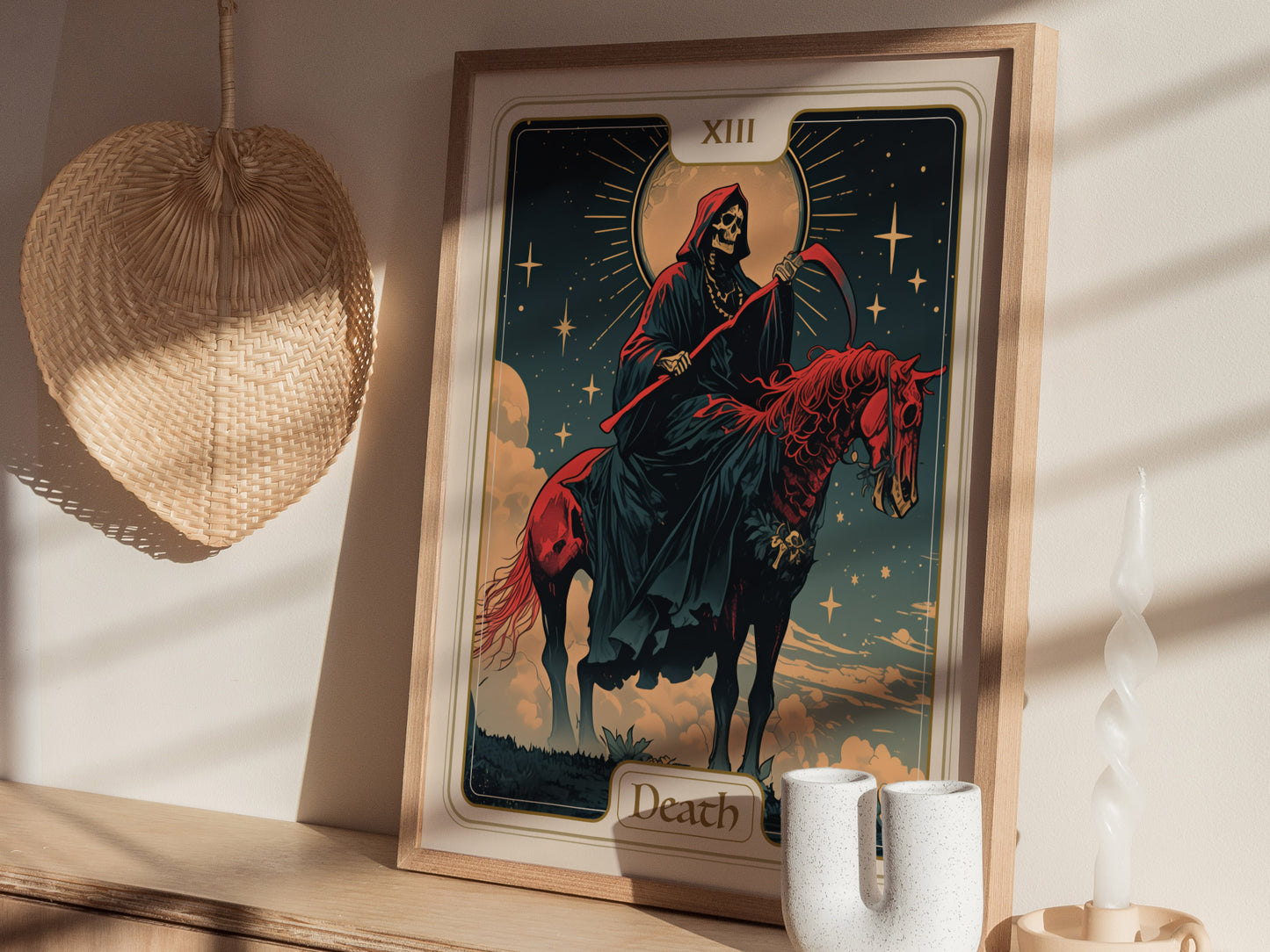 A framed Art Nouveau poster titled Death shows a skeletal rider on a red horse beneath a starry sky. It rests on a wooden shelf beside decorative items.