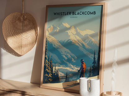 Framed Whistler Blackcomb poster depicting a skier in an orange jacket with snow-covered mountains, placed on a wooden shelf beside a wicker fan and decorative candle.