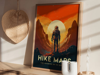 A framed Mars Hike poster features an astronaut standing between stylized Martian cliffs under a bright sun. It is displayed on a wooden shelf with a woven basket.