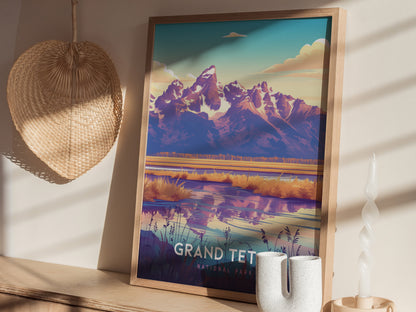Framed artwork of Grand Teton National Park with vibrant mountains and a reflective lake, displayed on a wooden shelf. Nearby, a woven basket and a twisted candle add decor elements.
