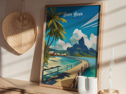 A framed Bora Bora travel print depicting turquoise lagoons, lush peaks, and overwater bungalows is displayed on a wooden surface next to a woven wall decor and candle.