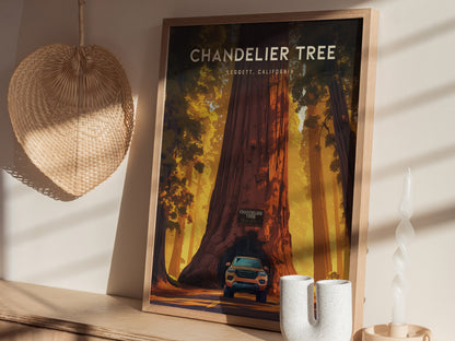 Framed art print depicting the Chandelier Tree with a car driving through its base, displayed on a wooden shelf alongside a woven basket and a spiral candle.