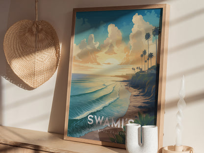 A framed poster of Swamis Encinitas Beach featuring a colorful sunset, palm trees, and waves is displayed on a shelf next to a woven hat and decorative candle.