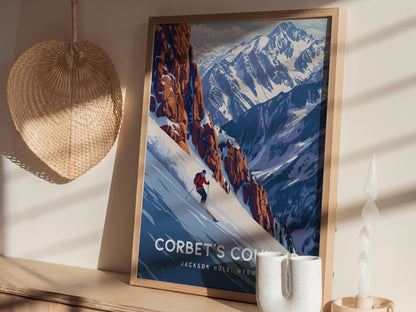 A framed poster of Corbet’s Couloir in Jackson Hole, Wyoming, shows a skier descending a steep snowy mountain, surrounded by rugged cliffs and majestic peaks.