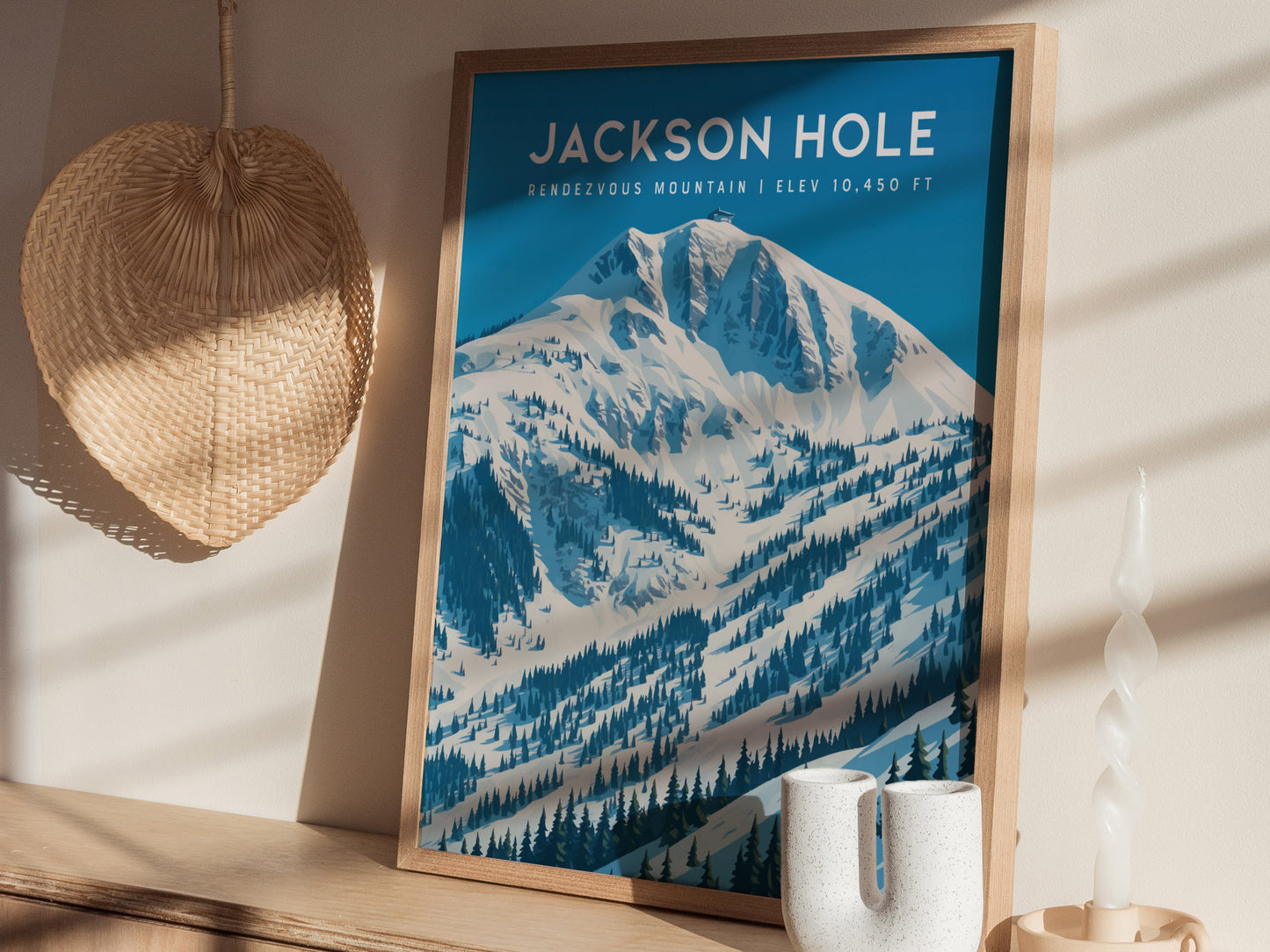 Framed Rendezvous Mountain wall art featuring a minimalist snow-covered landscape in shades of blue and white, showcasing Jackson Hole.