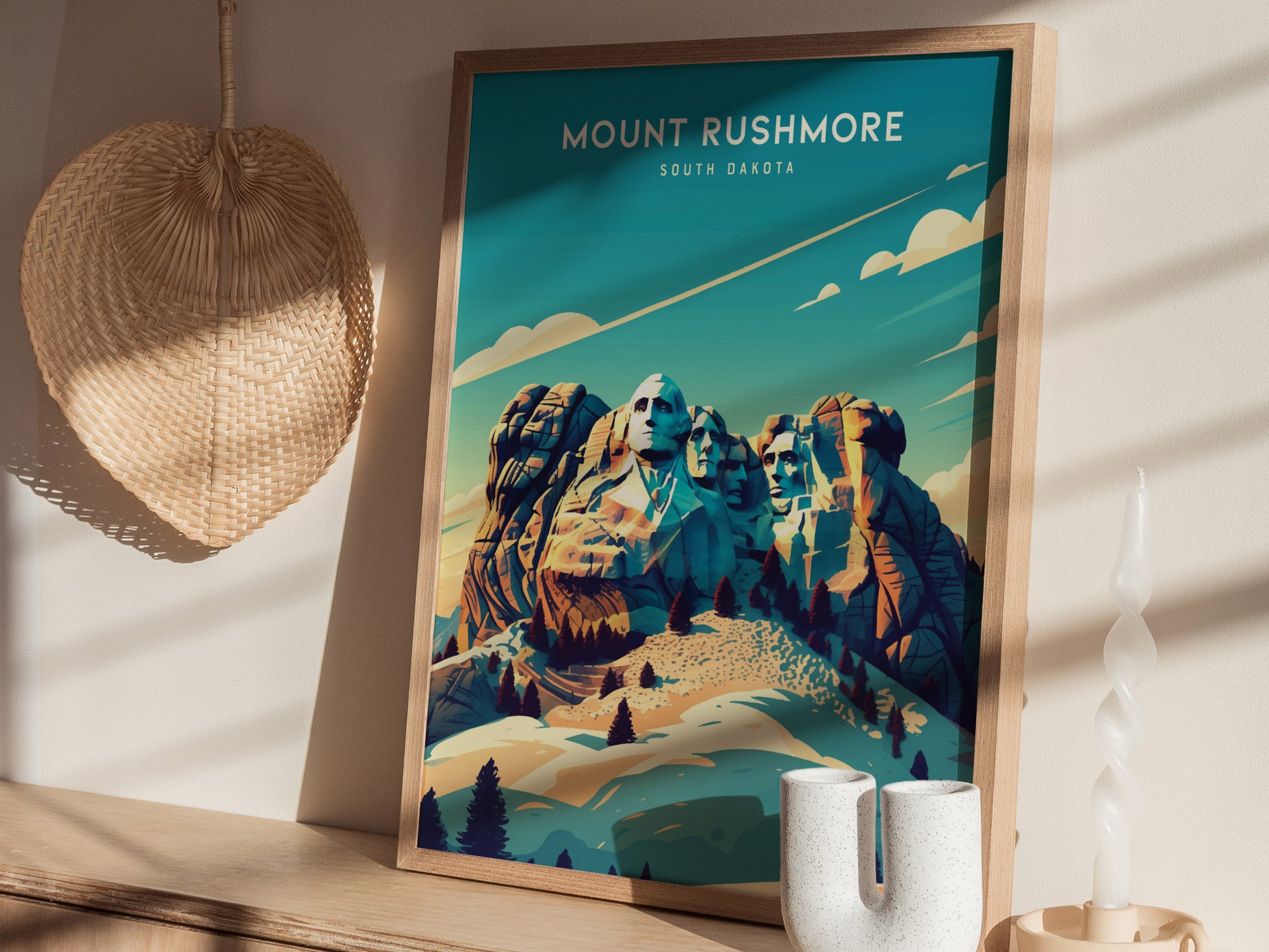 A framed Mount Rushmore poster with a vibrant, artistic depiction of the monument is displayed on a wooden shelf alongside a woven basket and a twisted candle.