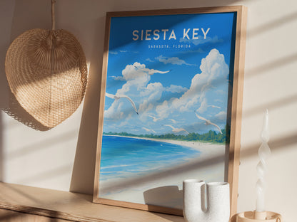 A framed Siesta Key, Sarasota, Florida poster with a beach scene sits on a wooden shelf. Nearby are a woven wall decoration and a uniquely shaped candle.