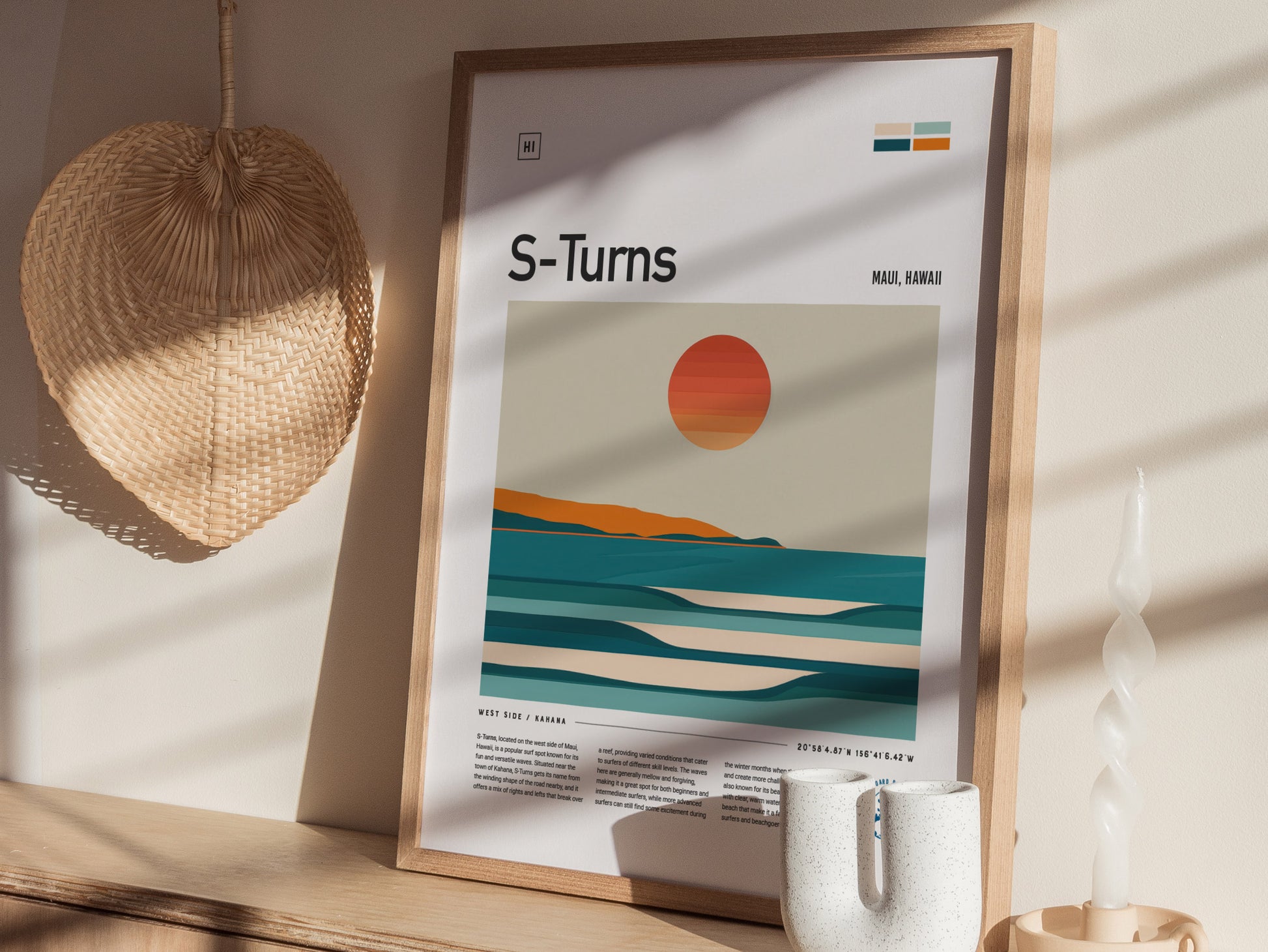A framed poster titled S-Turns depicting a minimalist sunset over ocean waves is displayed on a wooden shelf. Nearby are a woven basket and a white candle.