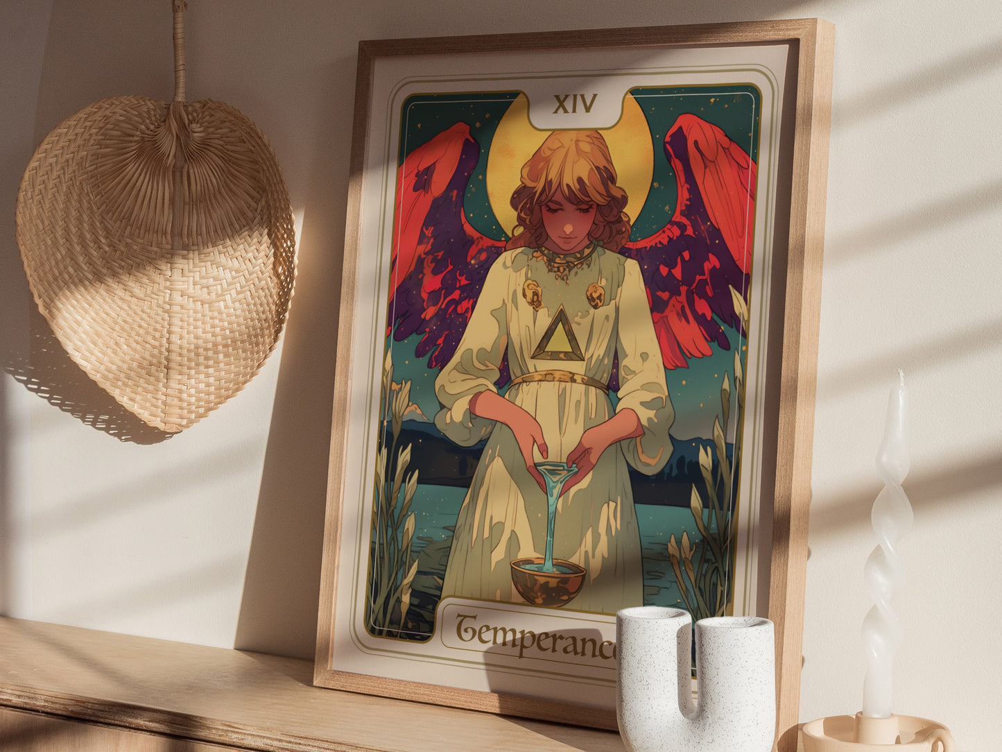 A framed Temperance Tarot poster features an angelic figure with vibrant red wings, wearing a white robe and pouring liquid between two cups.