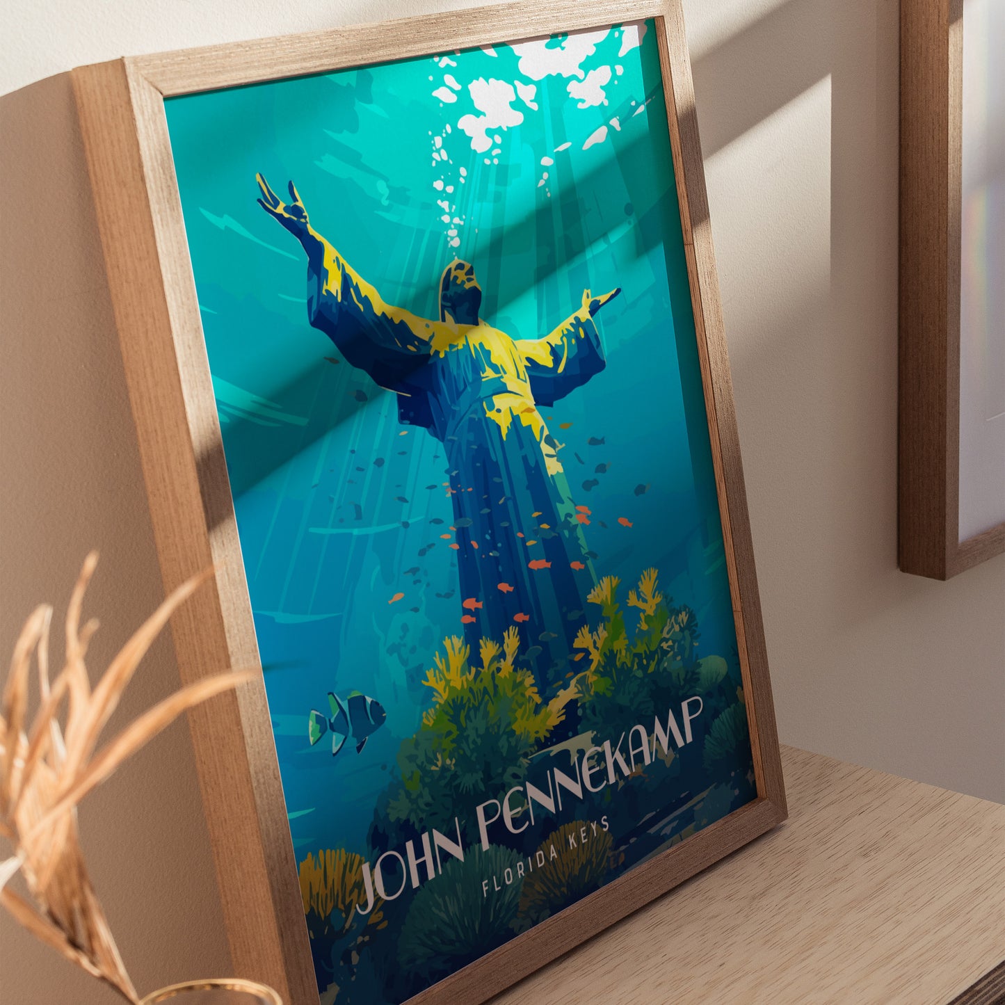 A framed poster depicts an underwater scene with a statue raising its arms, surrounded by colorful fish and corals, labeled John Pennekamp Florida Keys.