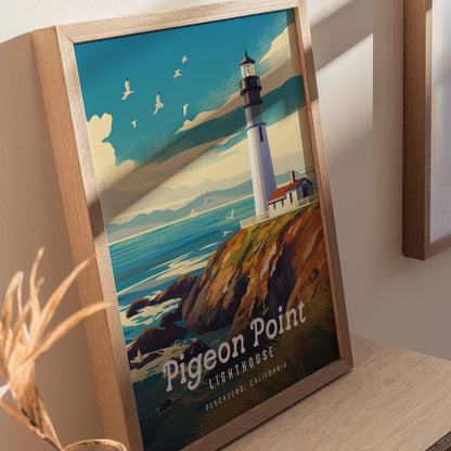 Framed artwork of Pigeon Point Lighthouse on a cliff overlooking the ocean, with seagulls flying in a blue sky. The image is set against a neutral wall.