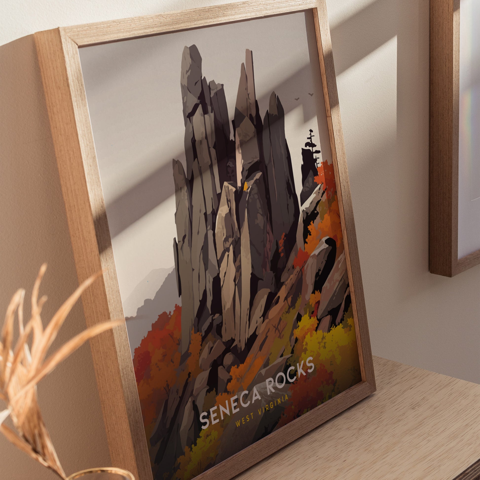 Framed poster depicting Seneca Rocks with jagged peaks and vibrant autumn foliage, set against a soft sky. The text reads Seneca Rocks West Virginia.