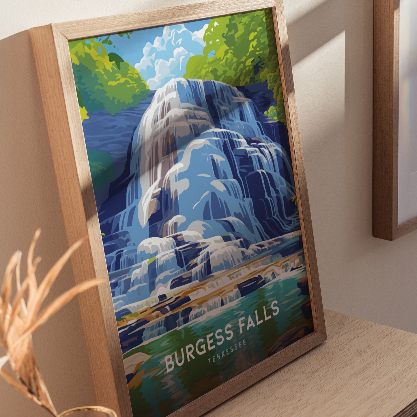 A framed poster of Burgess Falls in Tennessee showcases cascading blue and white waterfalls surrounded by lush green foliage.