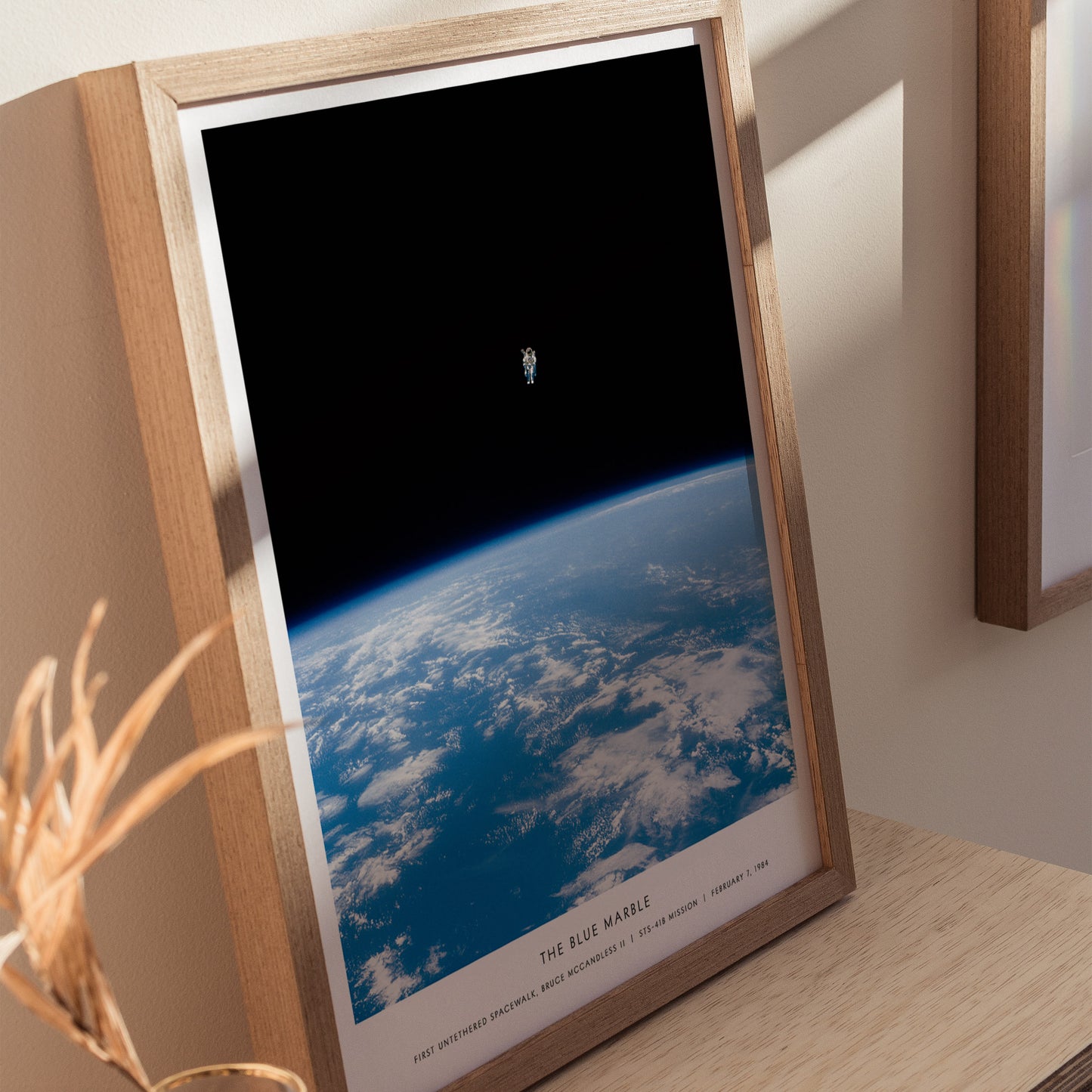 Framed photograph of Earth from space on a wooden surface