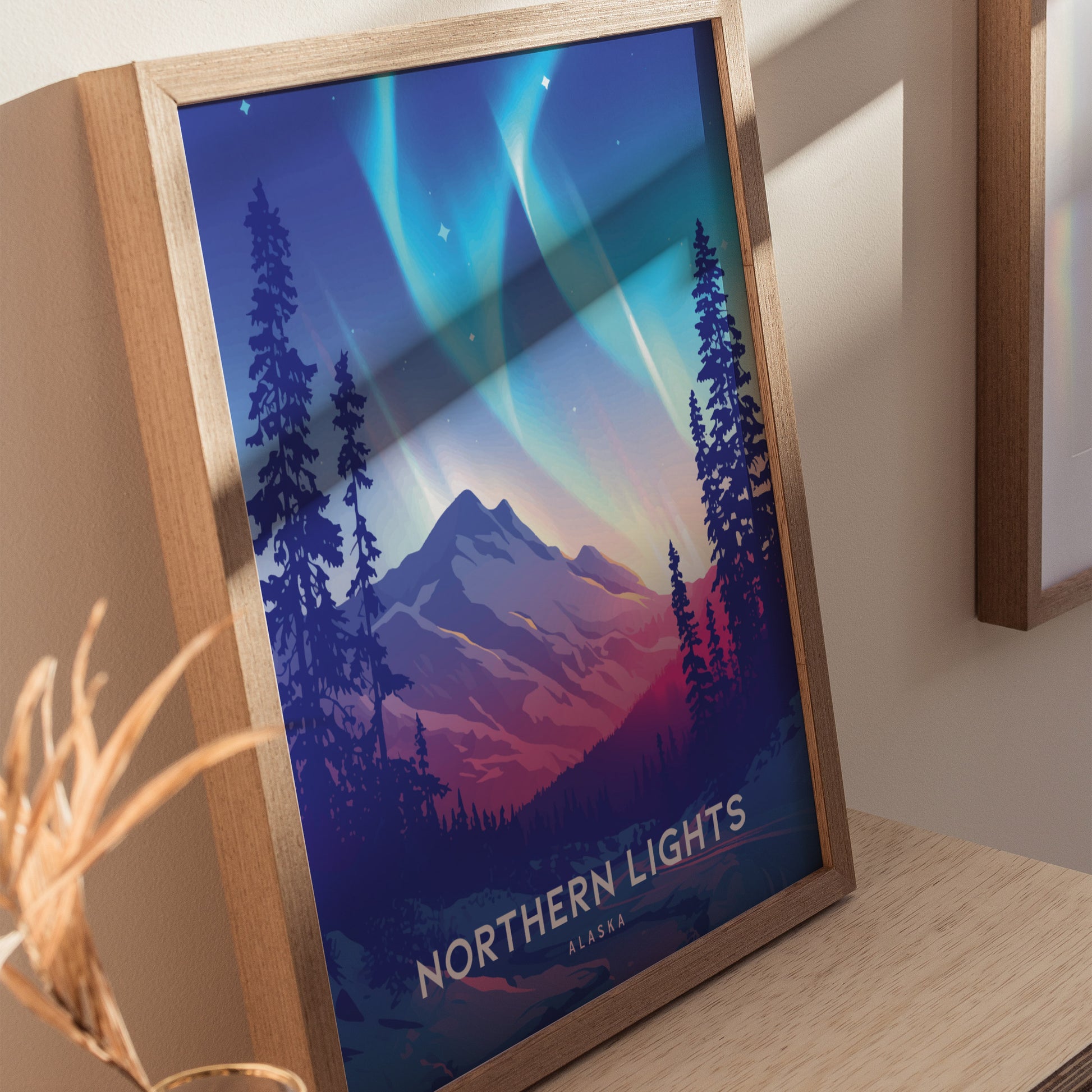 Framed poster featuring a colorful illustration of the Northern Lights over a mountainous landscape, surrounded by pine trees, with the text Northern Lights Alaska at the bottom.