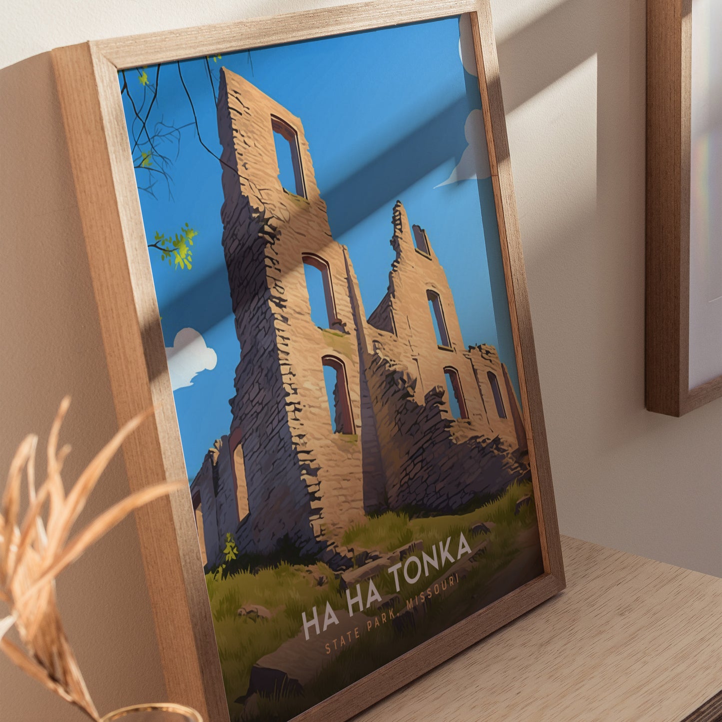 A framed poster of Ha Ha Tonka State Park, Missouri, depicts a sunlit stone castle ruin against a bright blue sky, with green foliage at the edges.